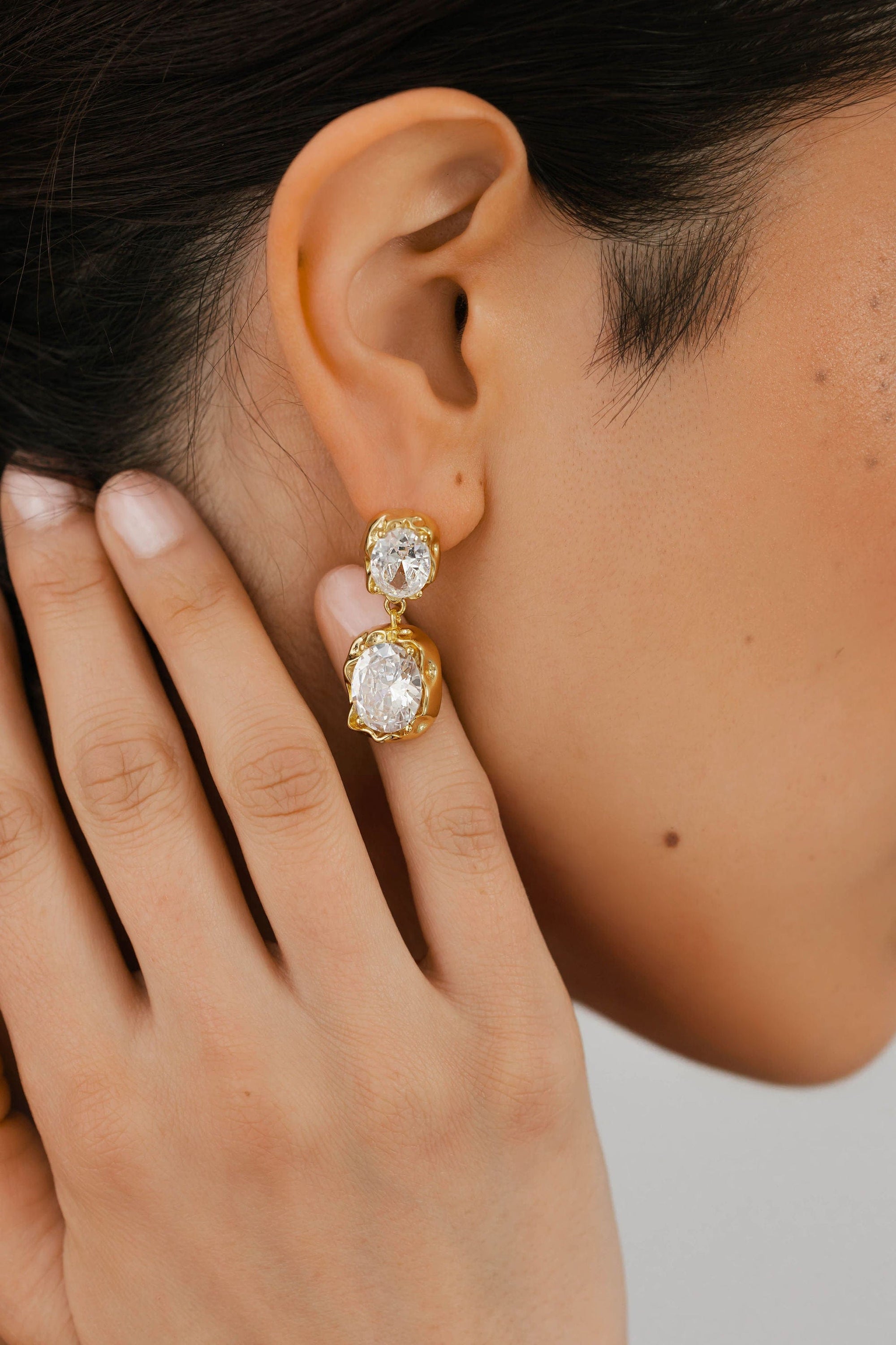 The Perfect Hoop Aura Casila Hoop in gold, worn by a model, featuring a chunky silhouette and textured gold finish for a modern statement look.