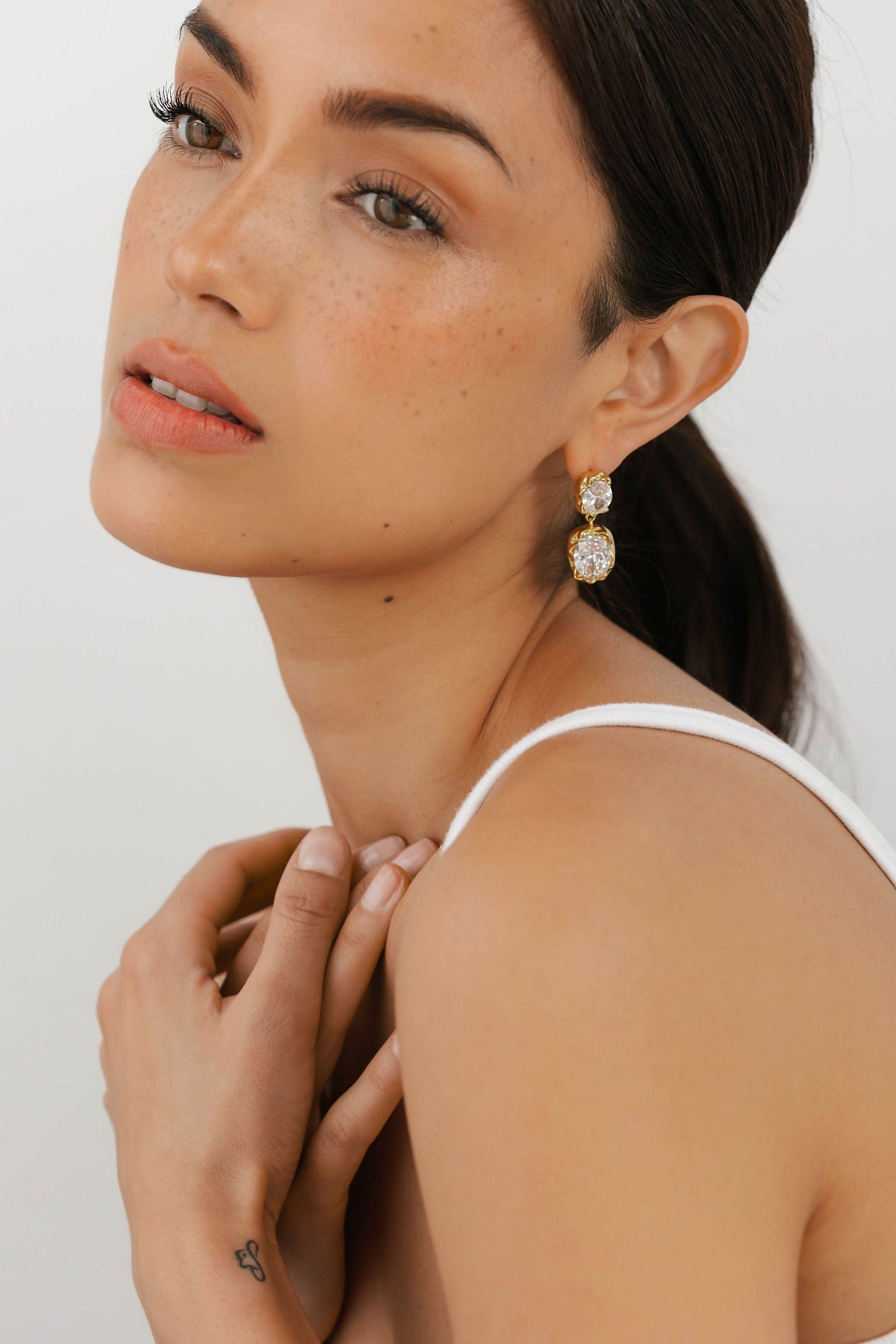 Close-up of The Aura Casila Hoop in gold by The Perfect Hoop, styled on model to highlight its contemporary rounded profile and chunky silhouette.