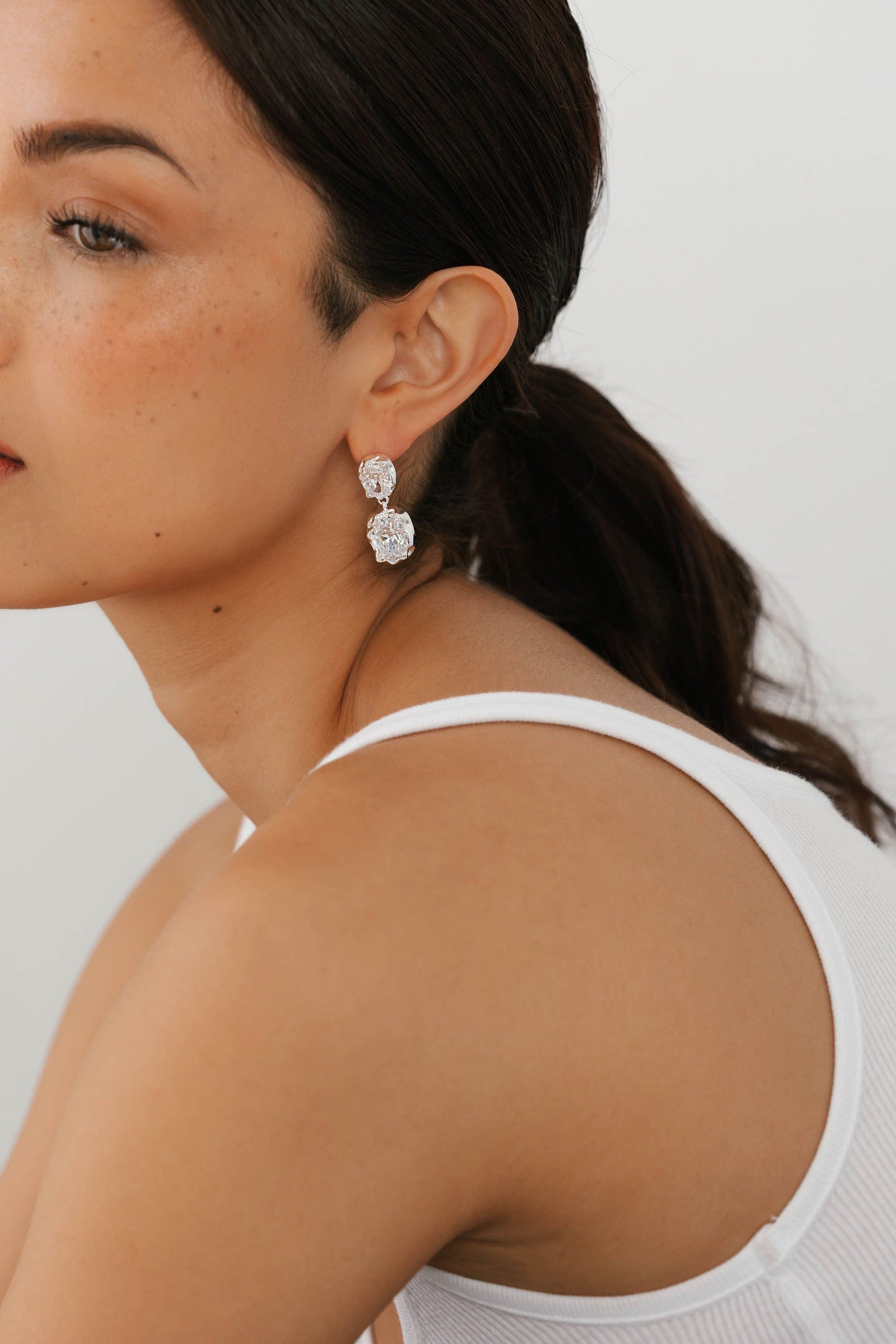 The Aura Casila Hoop in silver from The Perfect Hoop styled on model, featuring a bold, sculpted shape and reflective high-shine finish.