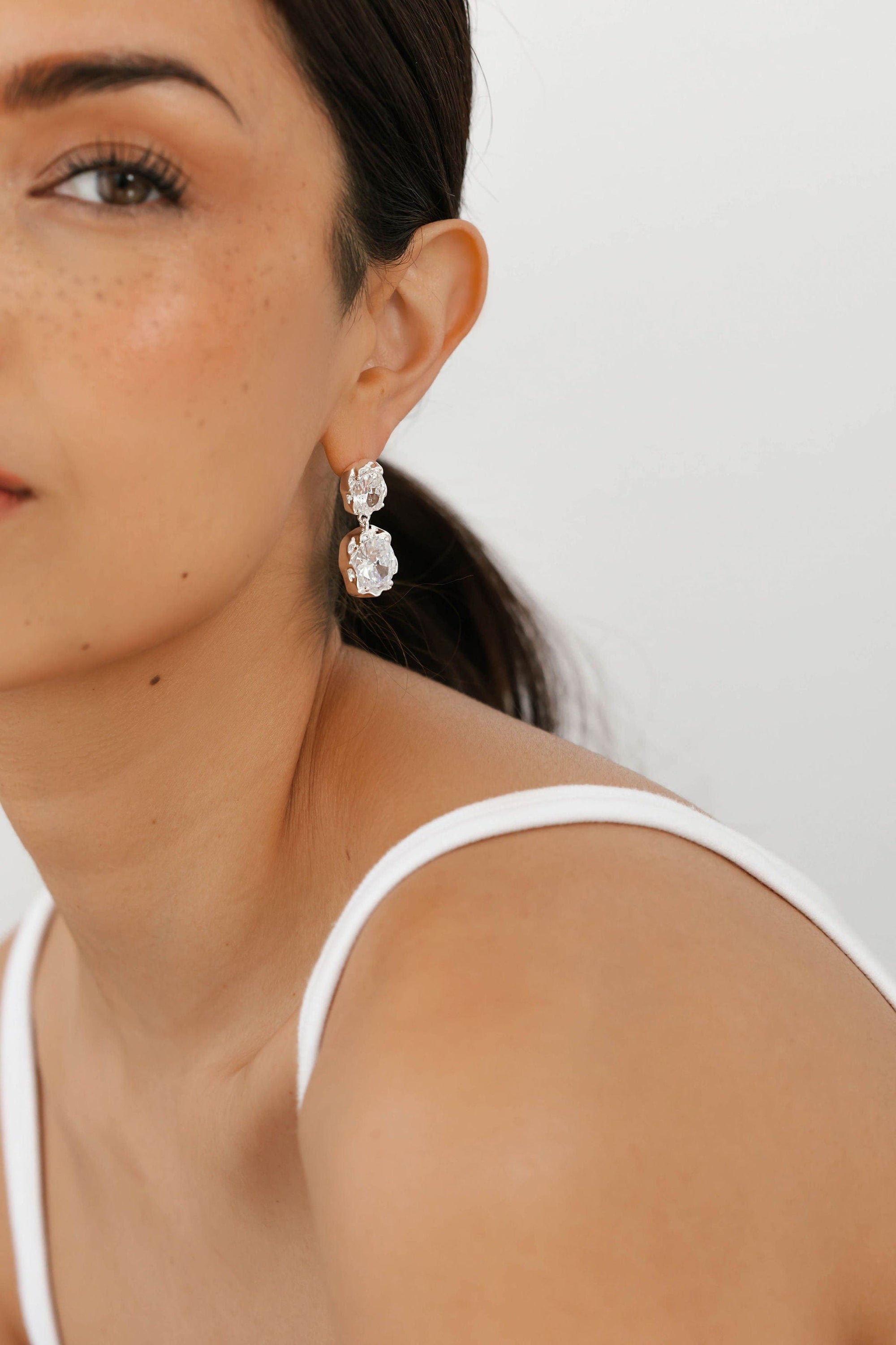 Close-up of The Aura Casila Hoop in sterling silver from The Perfect Hoop, emphasizing the modern sculptural design and soft luster.
