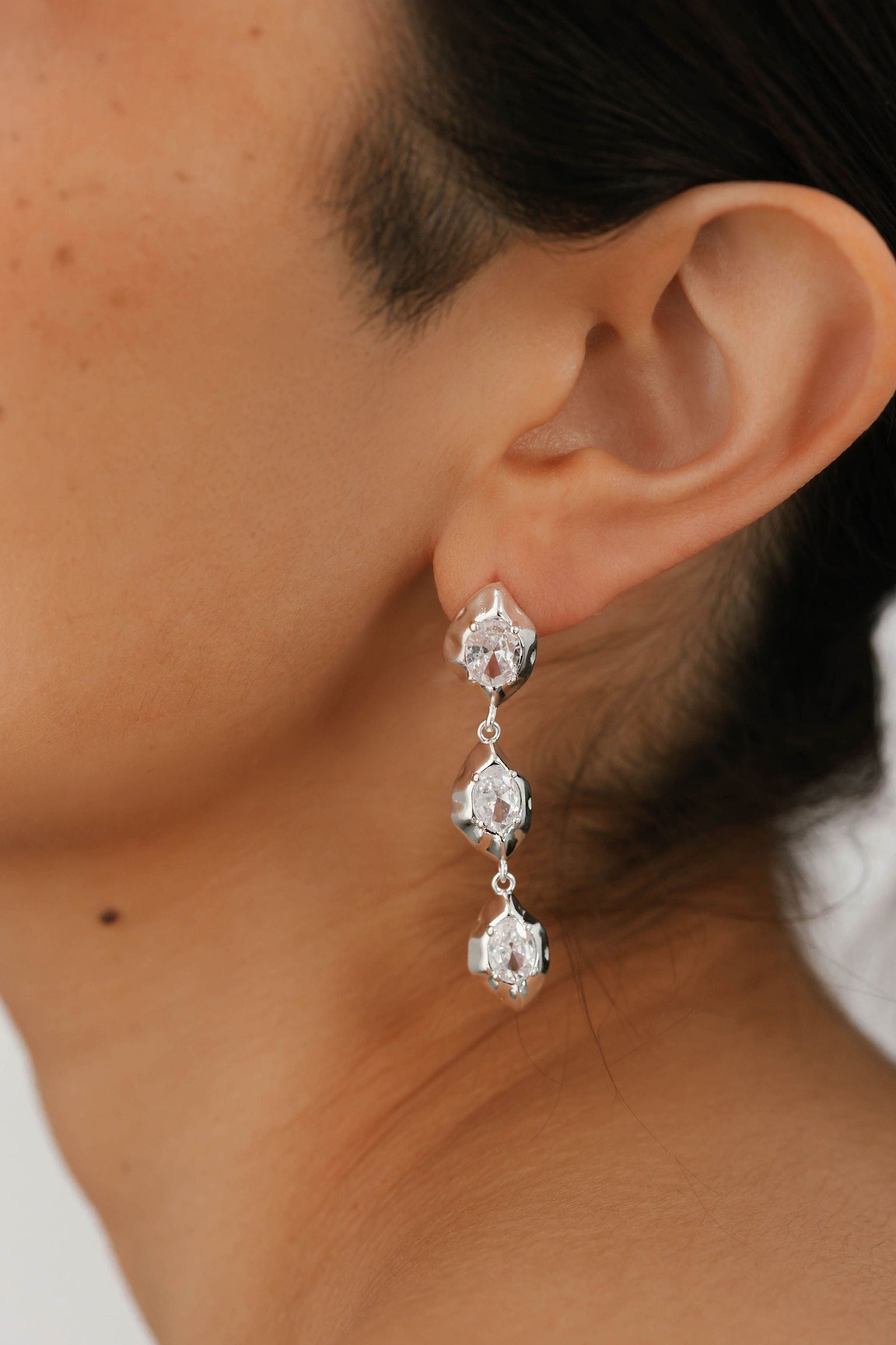 The Perfect Hoop Aura Drop Hoop in silver, close-up showcasing the dangle-style double crystal feature with high-shine sterling silver setting.